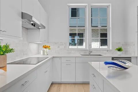 a kitchen with a sink and cabinets