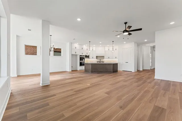 a view of a livingroom with furniture wooden floor and windows