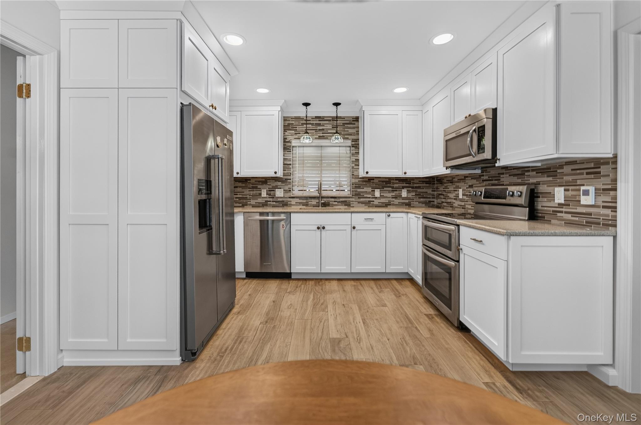 261 Hallock Road Stony Brook, NY 11790 - Photo 2 of 13 a kitchen with stainless steel appliances granite countertop a stove top oven a sink and white cabinets