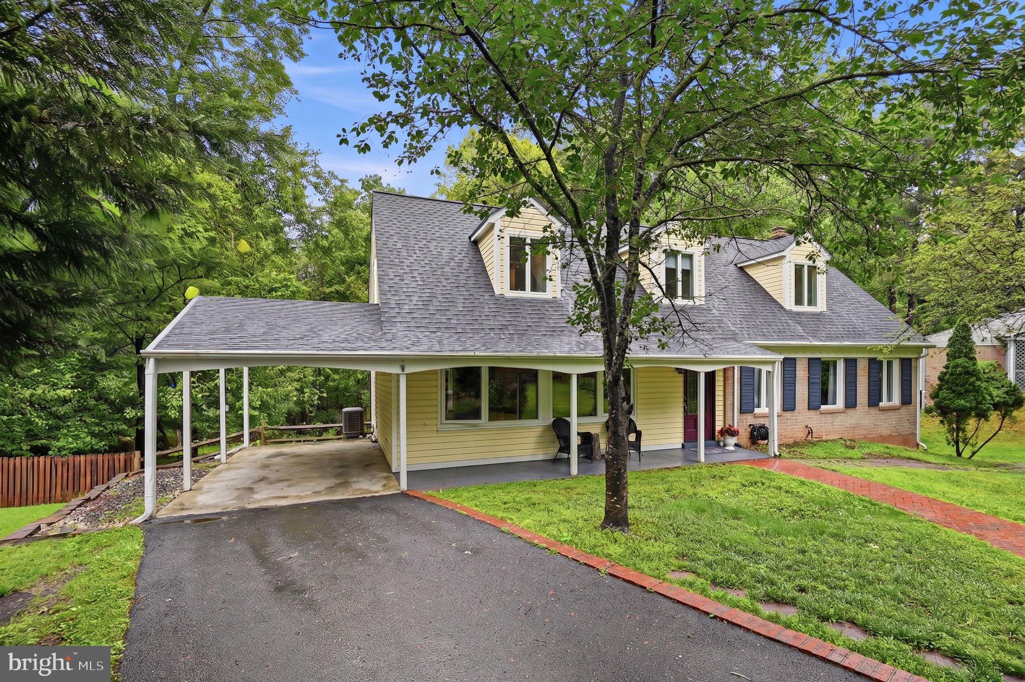 2506 Pinoak Lane Reston, VA 20191 - Photo 1 of 33 a front view of a house with a yard and trees