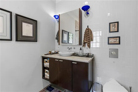 a bathroom with a toilet sink and mirror