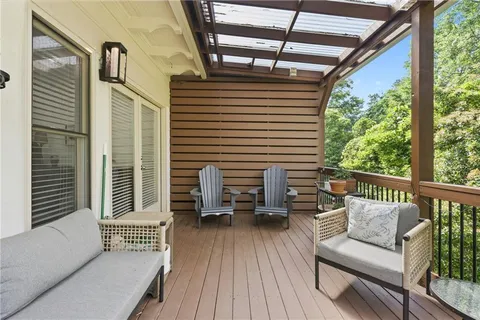 a view of a balcony with furniture and wooden floor