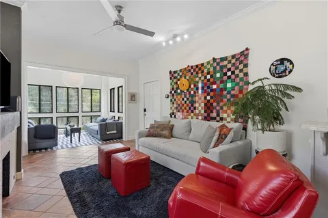 a living room with furniture ceiling fan and a rug