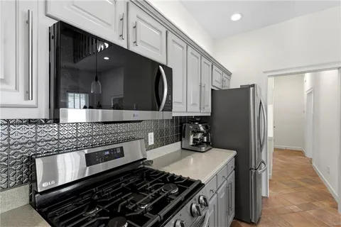 a kitchen with a stove and a refrigerator