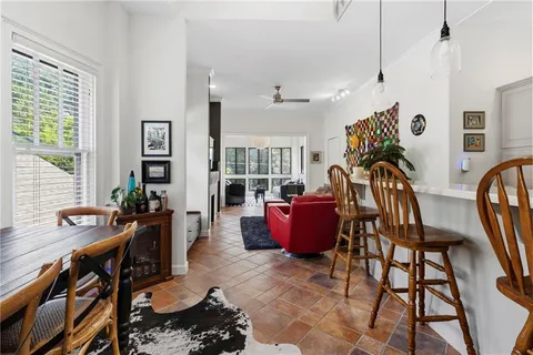 a living room with furniture a rug and a window