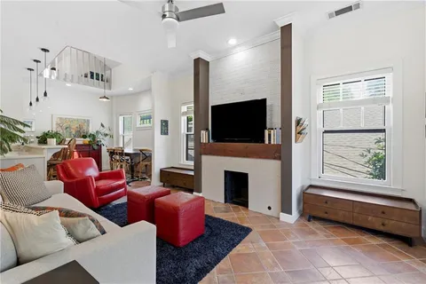 a living room with furniture a flat screen tv and a fireplace