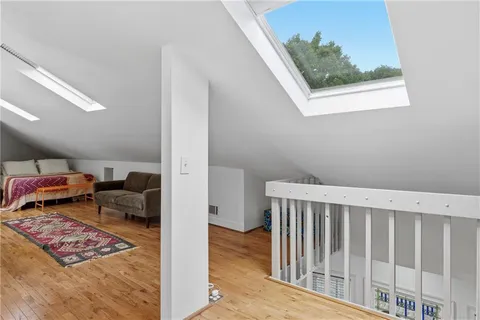 a view of a hallway with furniture and a rug
