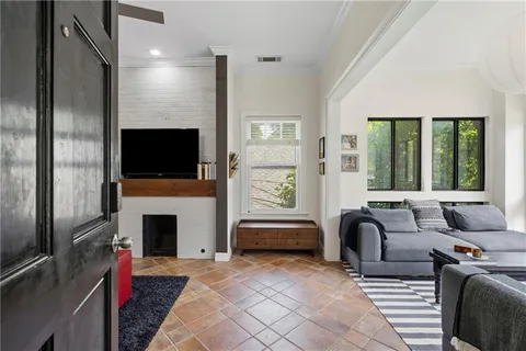 a living room with furniture flat screen tv and a fireplace