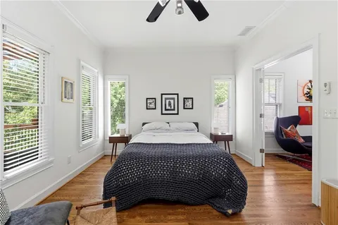 a bedroom with a bed and wooden floor