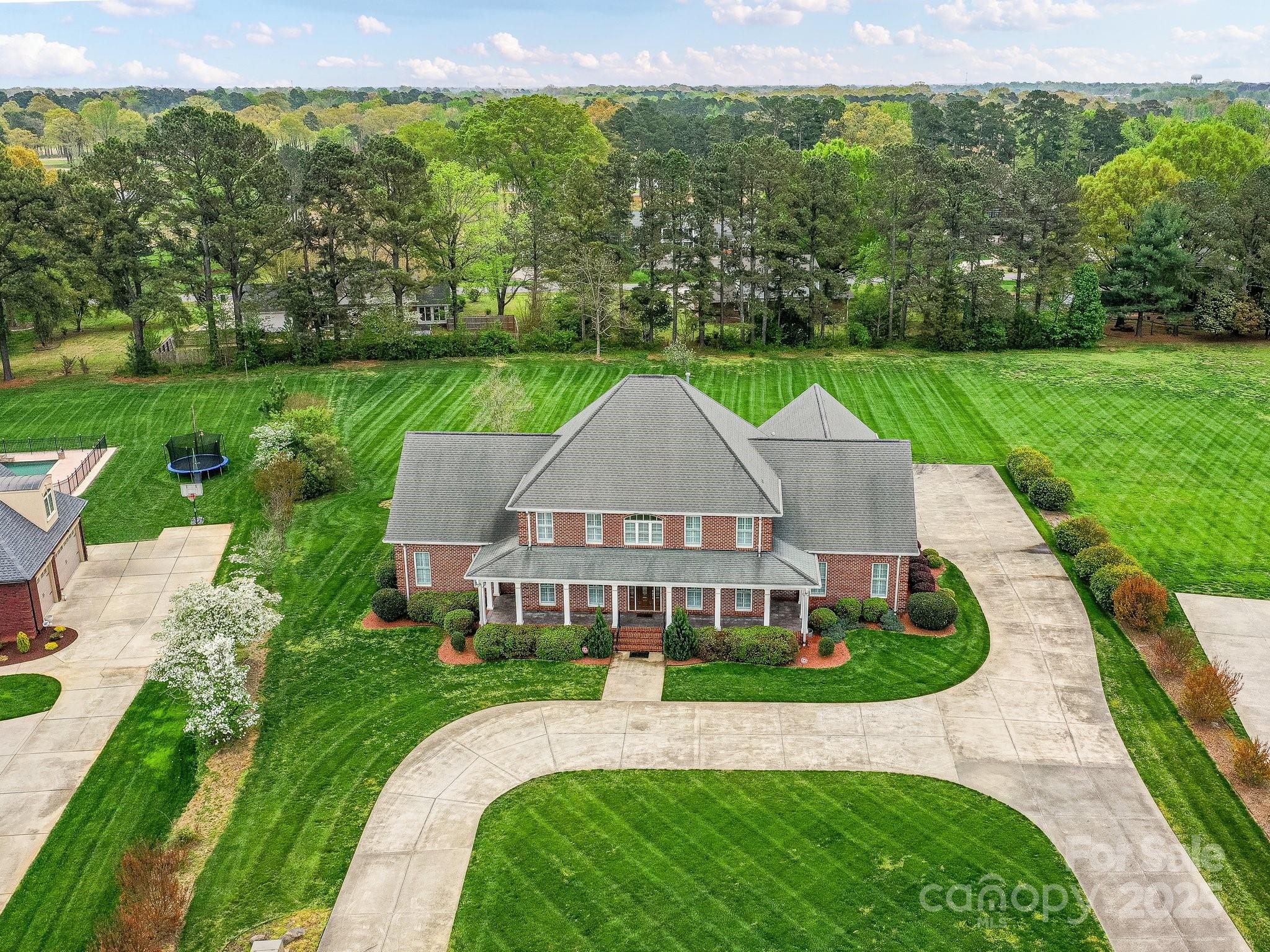 an aerial view of a house with big yard