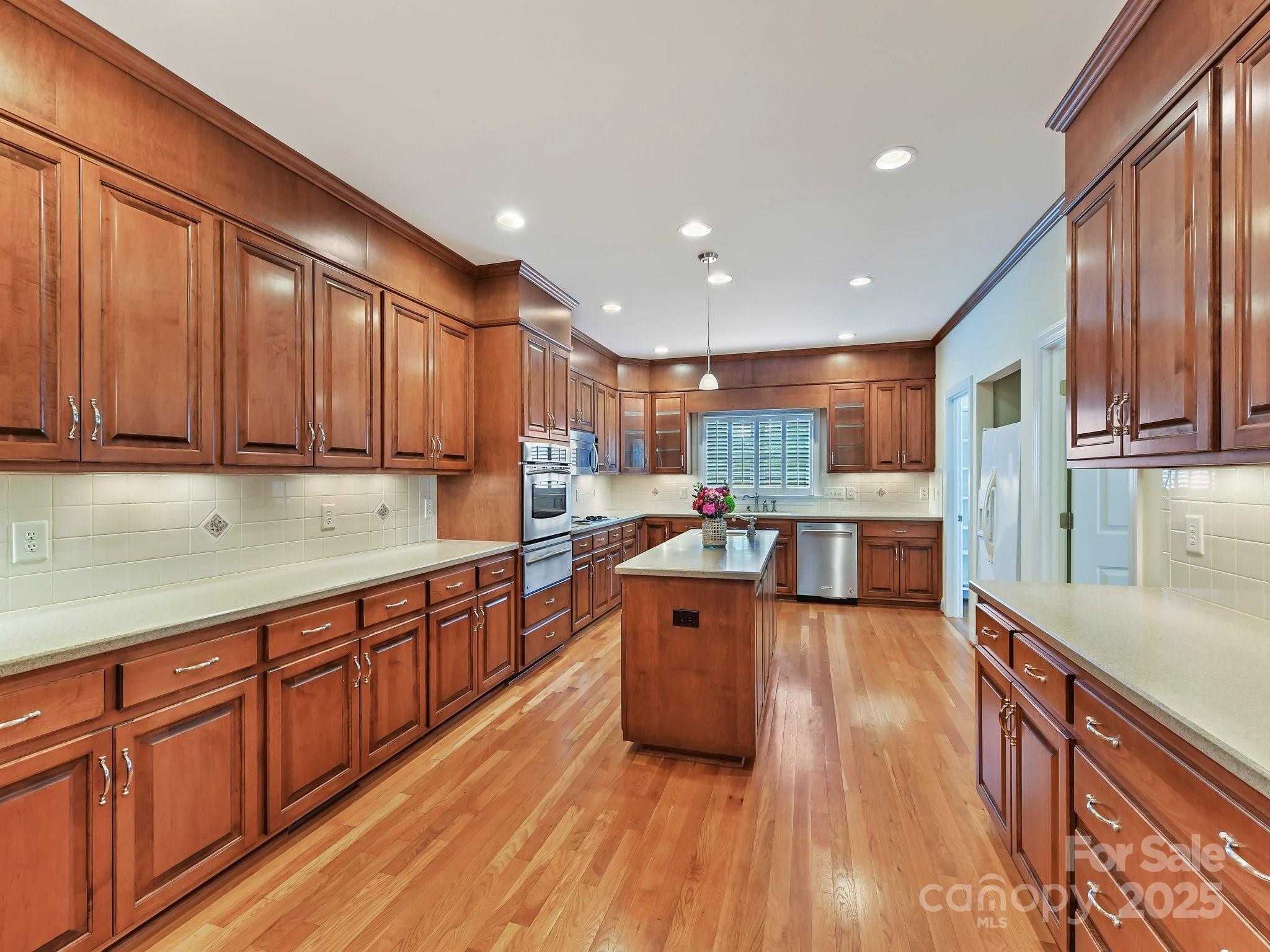 1902 Windmere Drive Monroe, NC 28110 - Photo 12 of 47 a large kitchen with stainless steel appliances wooden floors and wooden cabinets
