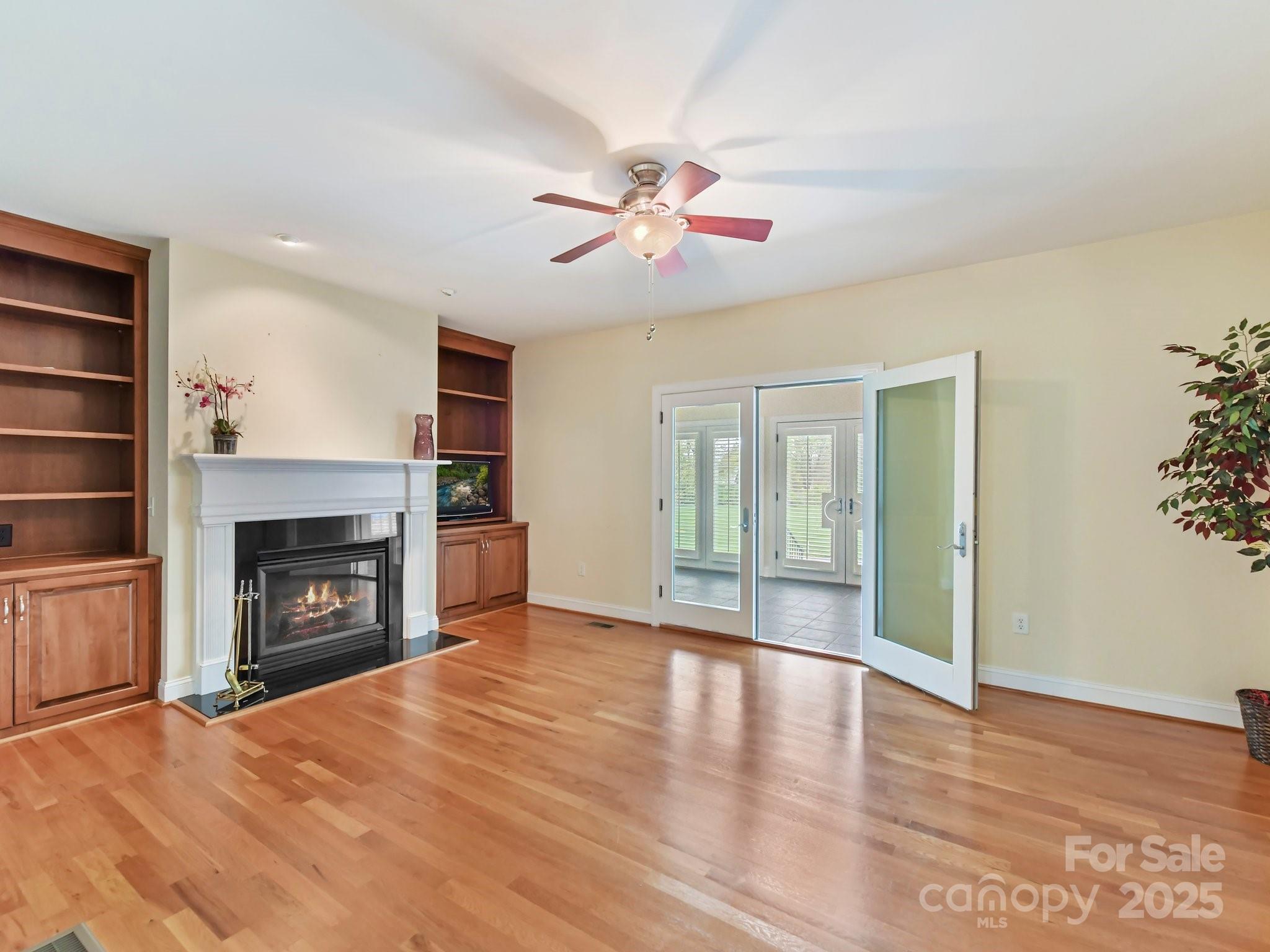 1902 Windmere Drive Monroe, NC 28110 - Photo 17 of 47 a view of an empty room with wooden floor fireplace and a window