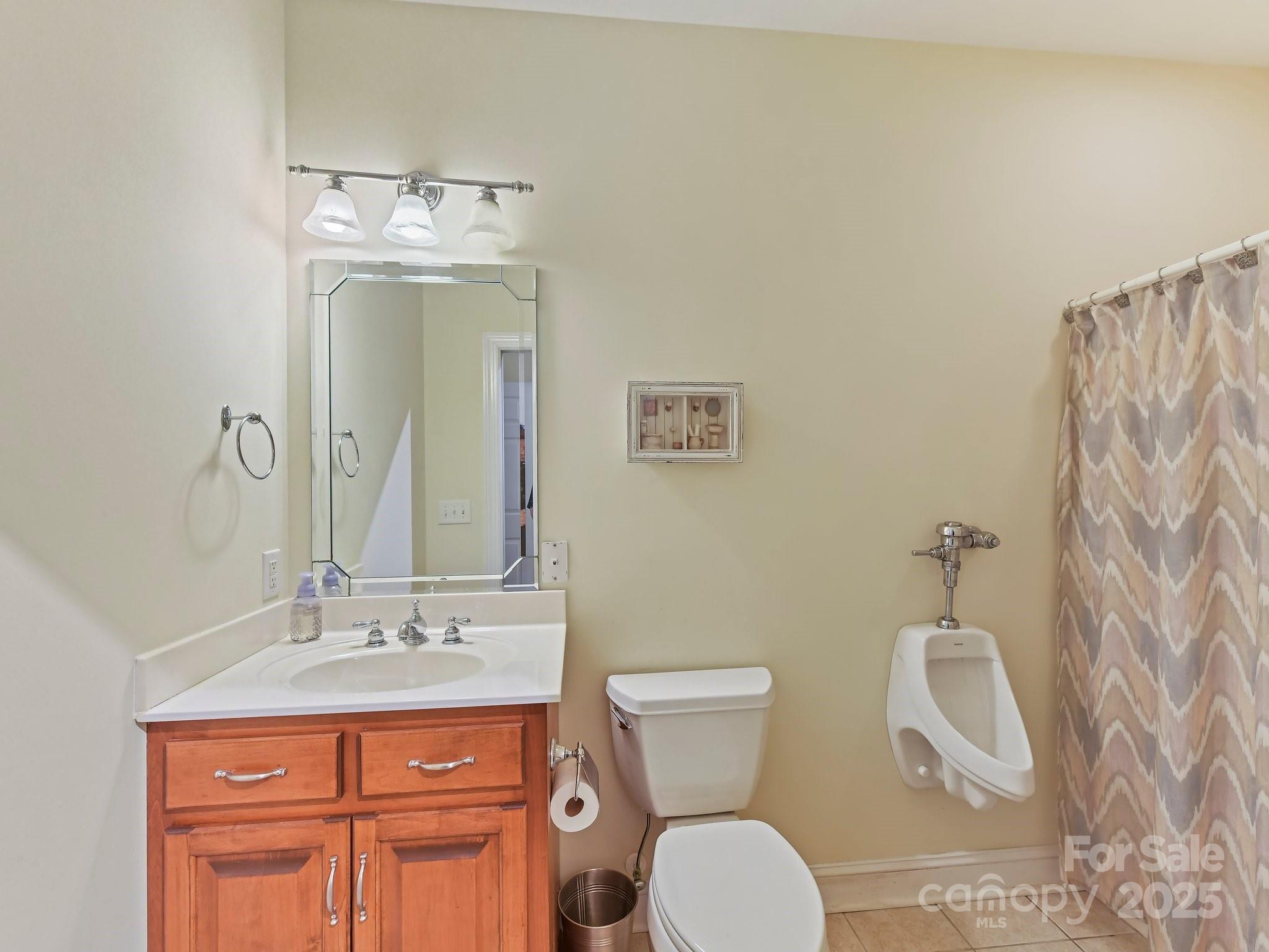 1902 Windmere Drive Monroe, NC 28110 - Photo 21 of 47 a bathroom with a toilet a sink and mirror