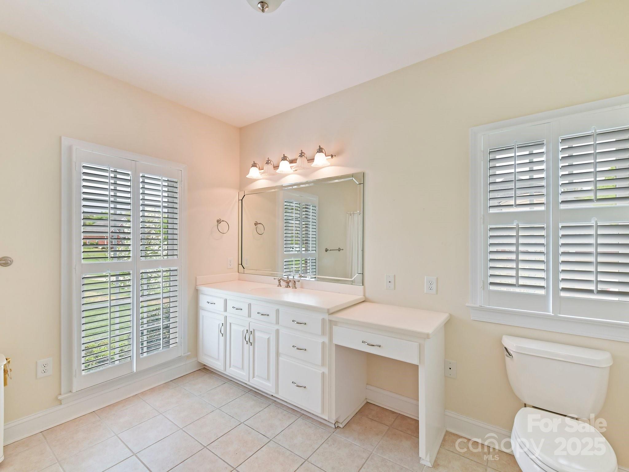 1902 Windmere Drive Monroe, NC 28110 - Photo 24 of 47 a spacious bathroom with a double vanity sink a large mirror and a toilet