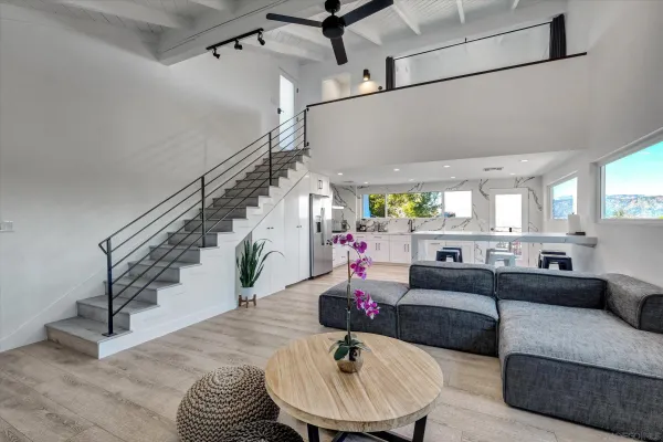 a living room with furniture and a dining table