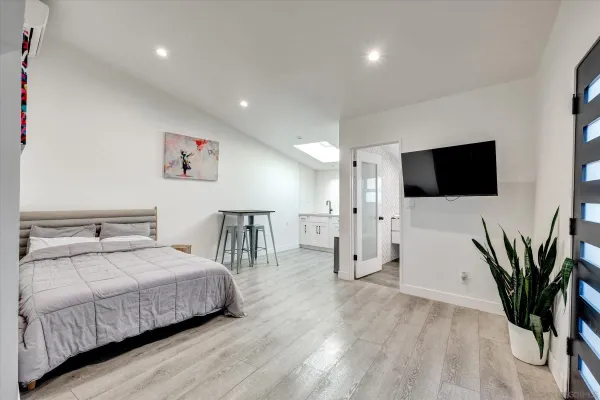a bedroom with a bed and a flat screen tv