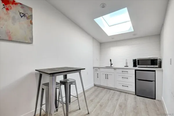 a kitchen with white cabinets and stainless steel appliances