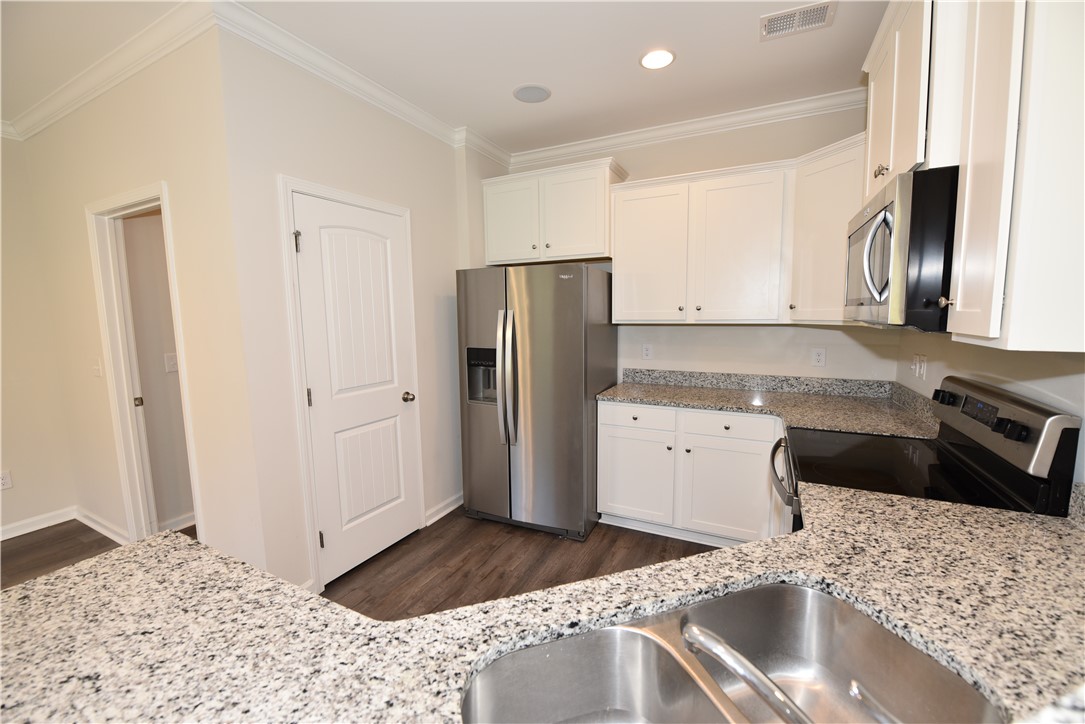 122 Bellflower Lane Anderson, SC 29625 - Photo 11 of 32 This kitchen showcases durable countertops and modern appliances, offering both style and utility.