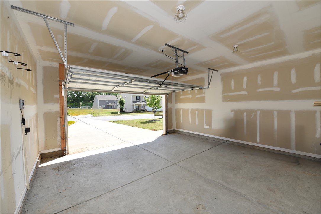 122 Bellflower Lane Anderson, SC 29625 - Photo 14 of 32 This spacious garage offers ample room and direct access to the concrete driveway.