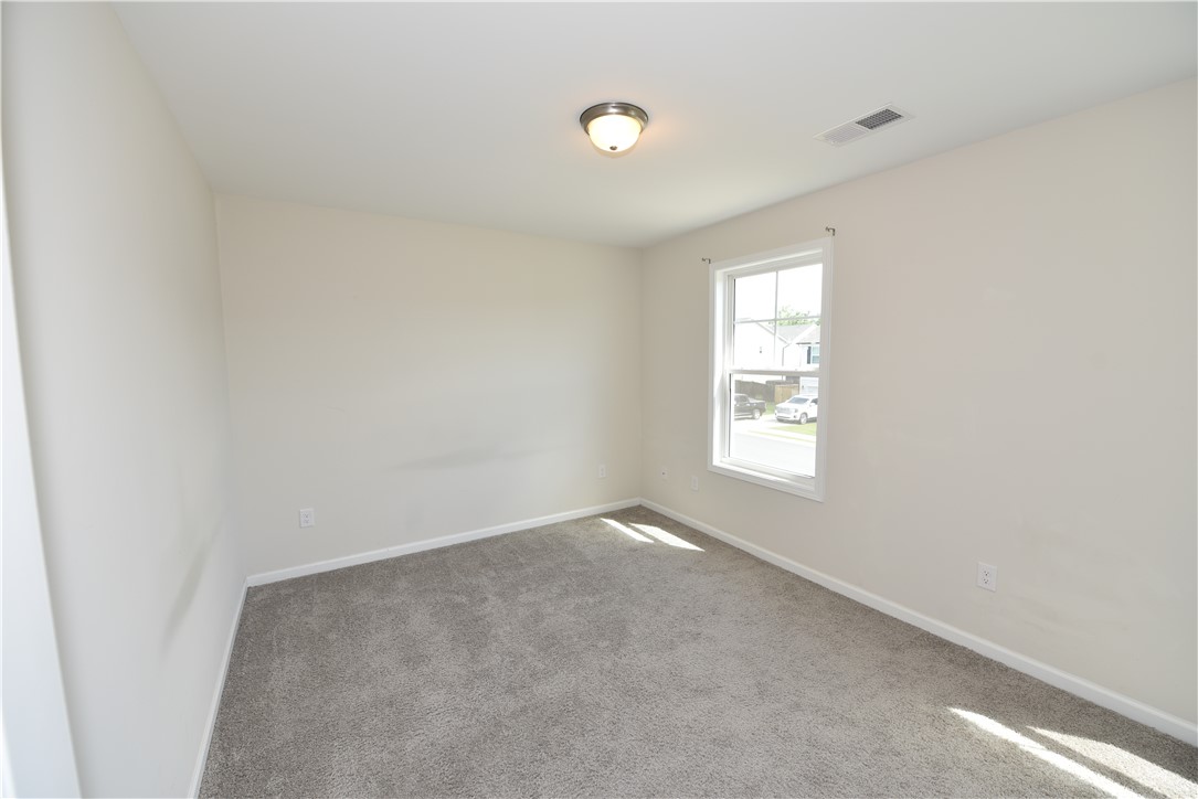 122 Bellflower Lane Anderson, SC 29625 - Photo 20 of 32 This bright bedroom provides a comfortable and inviting atmosphere for peaceful living.