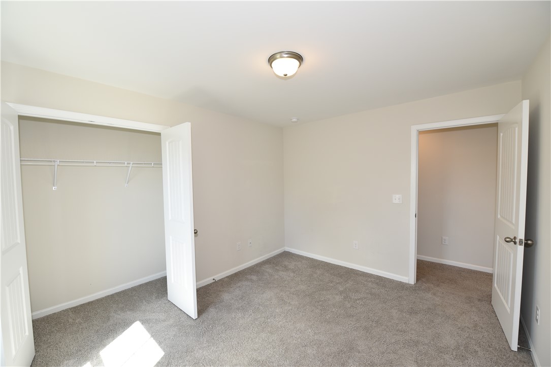 122 Bellflower Lane Anderson, SC 29625 - Photo 24 of 32 This spacious bedroom offers ample natural light and plush carpeting, ready for personalization.