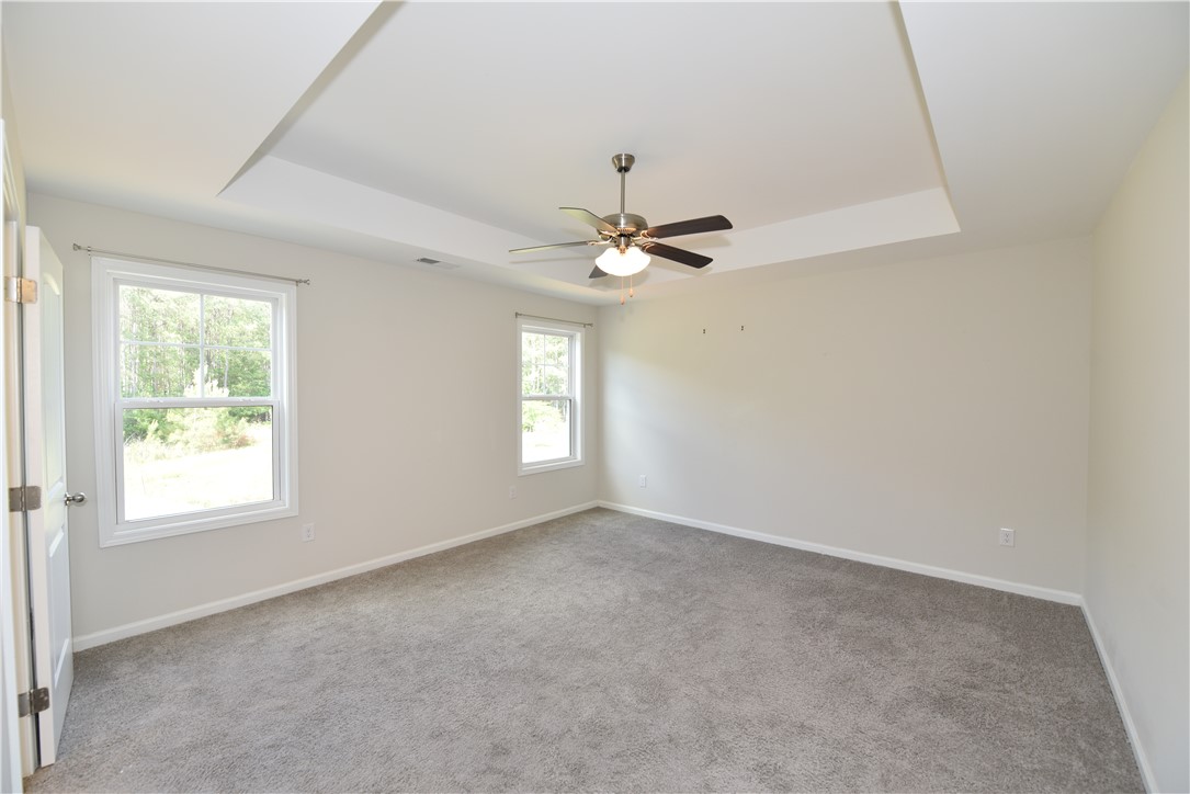 122 Bellflower Lane Anderson, SC 29625 - Photo 25 of 32 This primary bedroom offers ample natural light and a stylish tray ceiling.