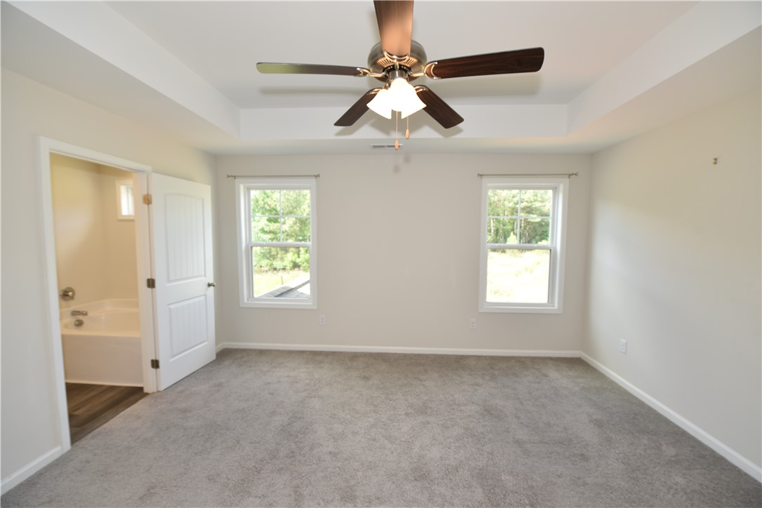 122 Bellflower Lane Anderson, SC 29625 - Photo 26 of 32 This inviting bedroom features a tray ceiling, ceiling fan, and ample natural light.