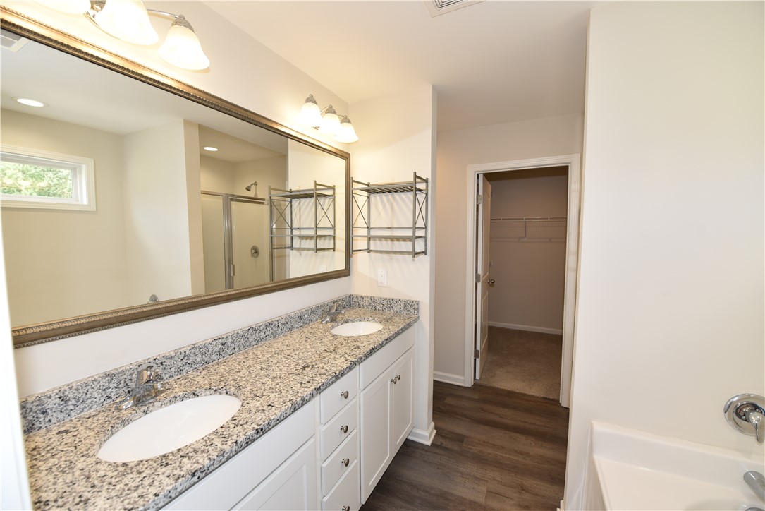 122 Bellflower Lane Anderson, SC 29625 - Photo 27 of 32 This primary bathroom offers dual sinks and a separate walk-in closet for ample storage.
