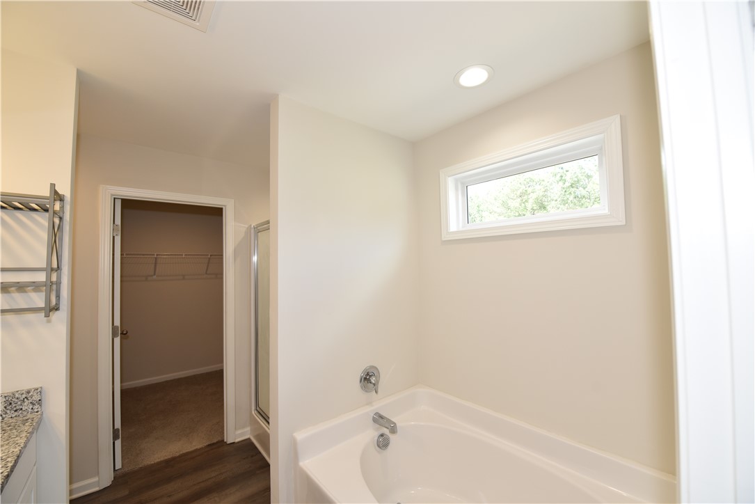 122 Bellflower Lane Anderson, SC 29625 - Photo 28 of 32 This primary bathroom features a window above the soaking tub, creating a bright and airy atmosphere.
