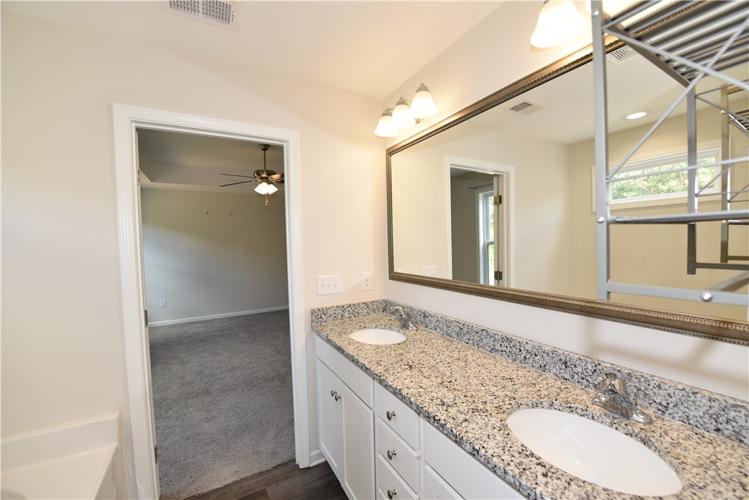 122 Bellflower Lane Anderson, SC 29625 - Photo 30 of 32 This primary bathroom features a double vanity and a spacious mirror, perfect for daily routines.