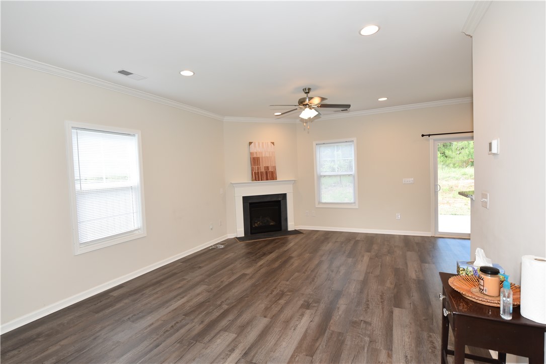 122 Bellflower Lane Anderson, SC 29625 - Photo 5 of 32 This bright living space features sleek flooring, a modern fireplace, and direct access to outdoor serenity.