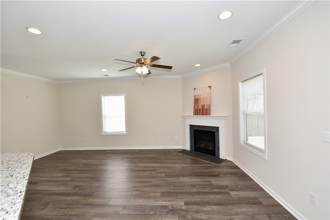 122 Bellflower Lane Anderson, SC 29625 - Photo 6 of 32 This inviting living space features modern flooring and a classic fireplace, perfect for daily living.