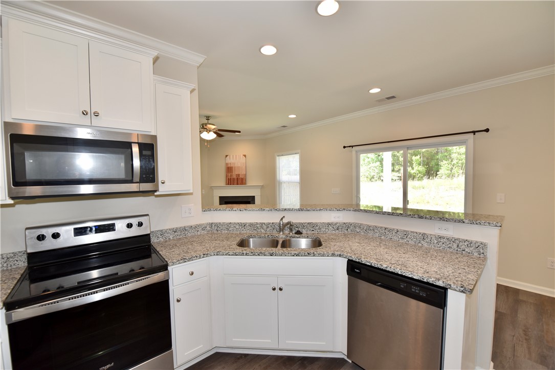 122 Bellflower Lane Anderson, SC 29625 - Photo 9 of 32 This modern kitchen features durable countertops, stainless steel appliances, and a view of the outdoors.