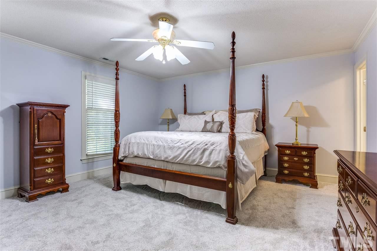 620 Downpatrick Lane Raleigh, NC 27615 - Photo 19 of 23 a bedroom with a bed chandelier and a dresser