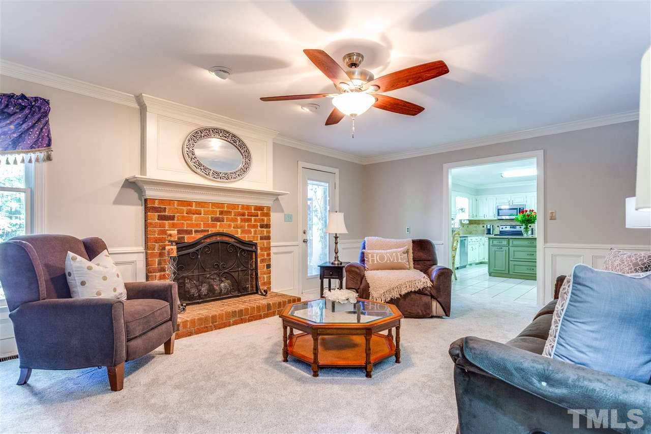 620 Downpatrick Lane Raleigh, NC 27615 - Photo 9 of 23 a living room with furniture and a fireplace