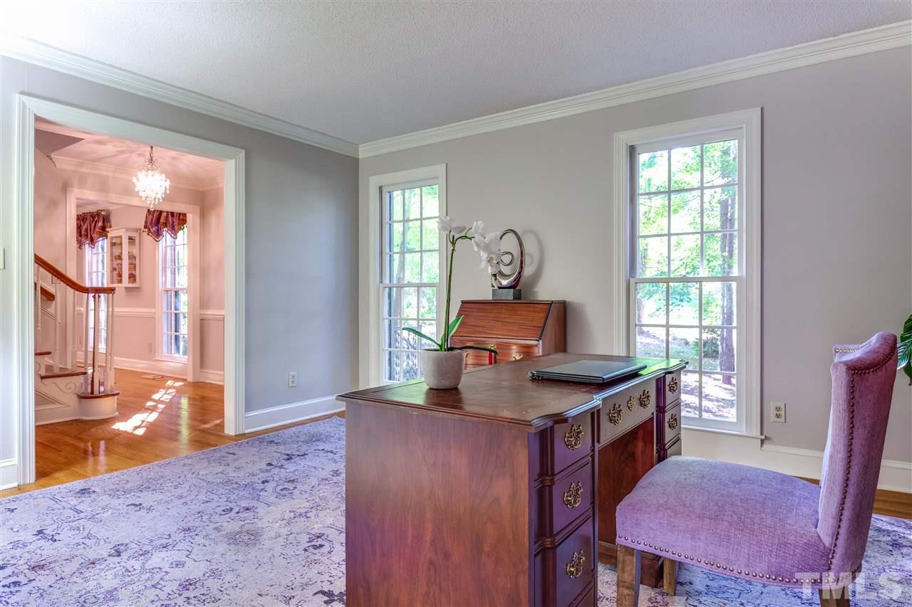 620 Downpatrick Lane Raleigh, NC 27615 - Photo 10 of 23 a kitchen with granite countertop a stove a sink and a dining table