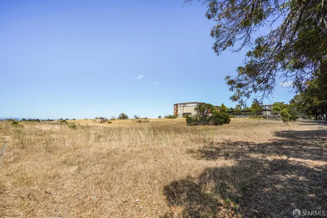 a view of a lake with beach and city view