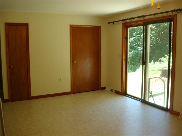 159 Old Sunderland Road Montague, MA 01351 - Photo 8 of 14 an empty room with wooden floor and windows