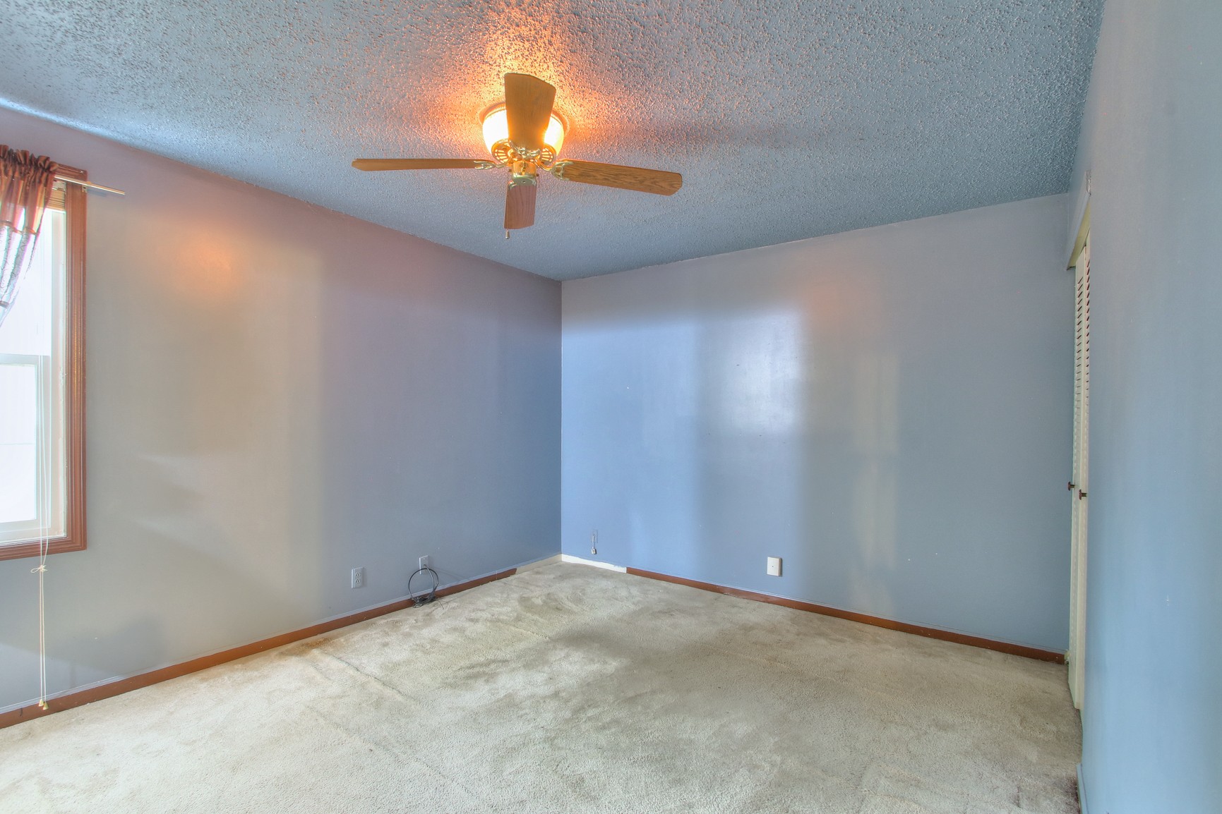 221 Warrior Road Madison, TN 37115 - Photo 8 of 13 an empty room with a chandelier fan and windows