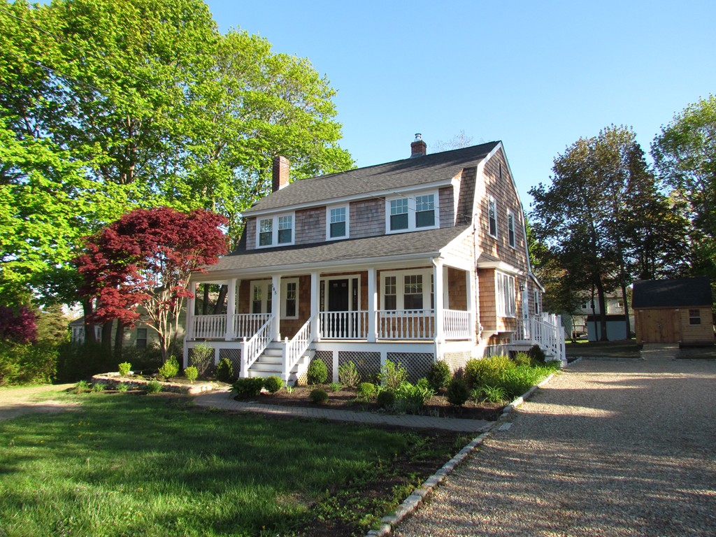 185 First Parish Road Scituate, MA 02066 - Photo 1 of 28 a front view of a house with a garden and trees