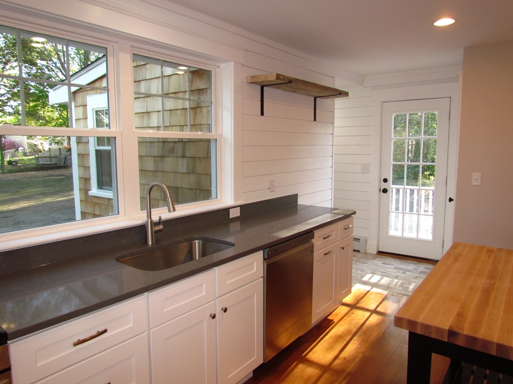 185 First Parish Road Scituate, MA 02066 - Photo 12 of 28 a kitchen with stainless steel appliances granite countertop a sink a stove and a granite counter tops with a large window