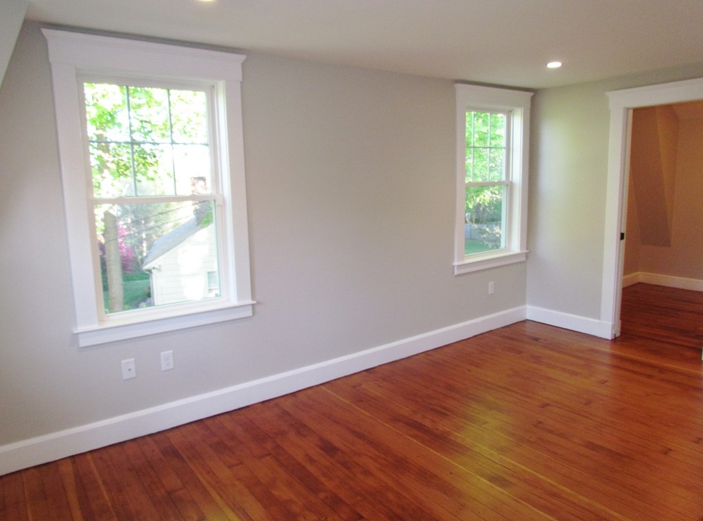 185 First Parish Road Scituate, MA 02066 - Photo 19 of 28 an empty room with wooden floor and windows