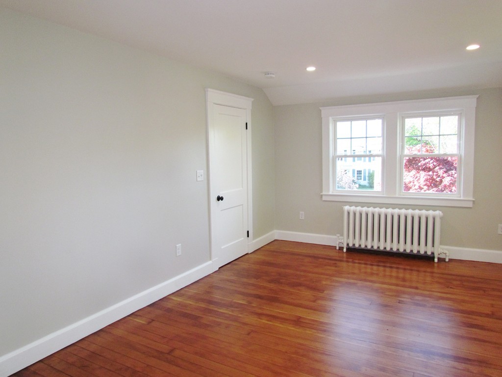 185 First Parish Road Scituate, MA 02066 - Photo 20 of 28 an empty room with wooden floor and windows
