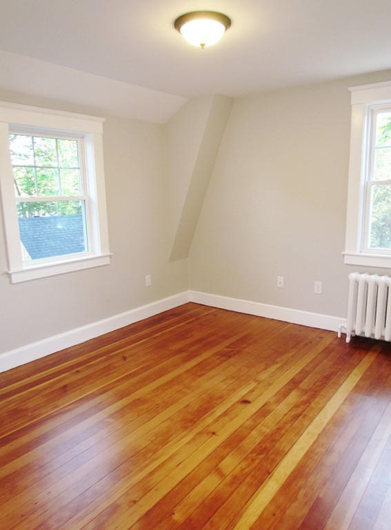185 First Parish Road Scituate, MA 02066 - Photo 25 of 28 an empty room with wooden floor and windows
