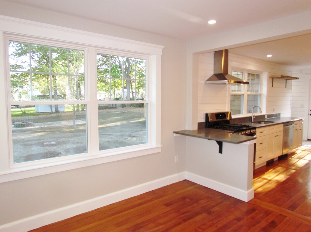 185 First Parish Road Scituate, MA 02066 - Photo 8 of 28 a kitchen with kitchen island granite countertop a stove and a large window