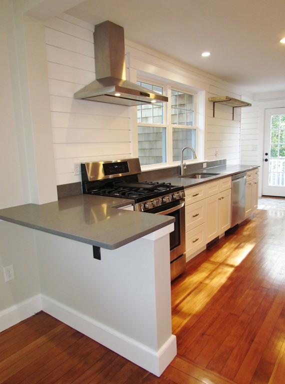 185 First Parish Road Scituate, MA 02066 - Photo 9 of 28 a kitchen with granite countertop a stove and a wooden floors