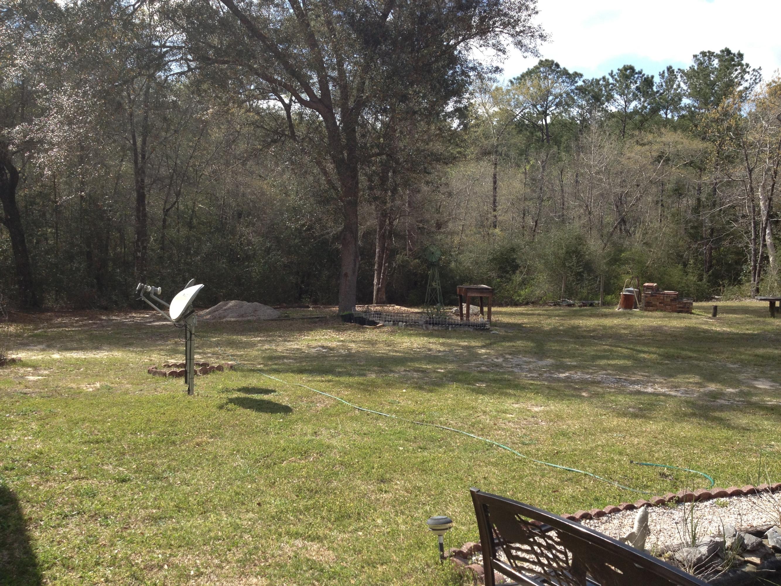 4217 Poverty Creek Road Crestview, FL 32539 - Photo 3 of 8 a swimming pool with trees in the background