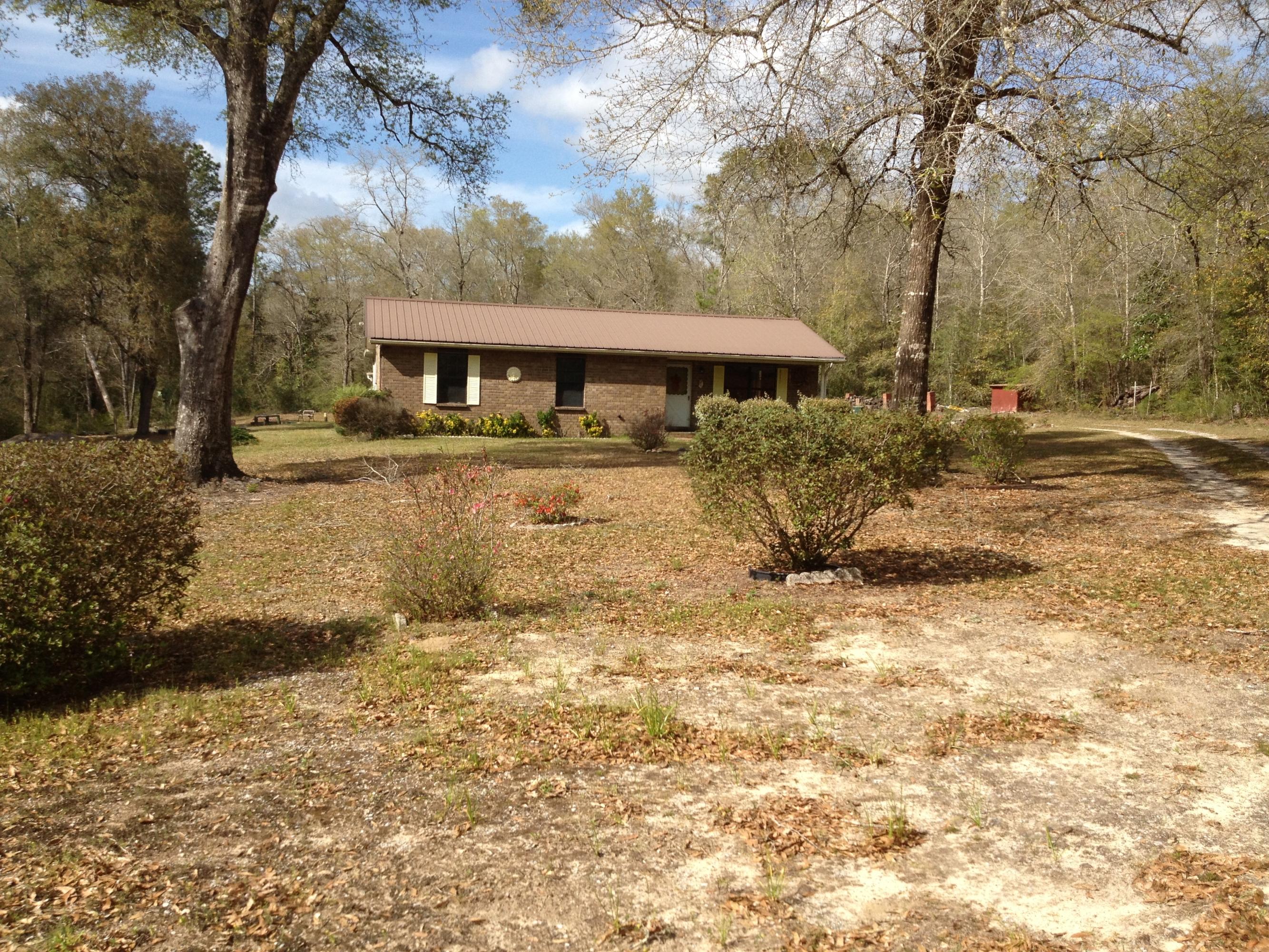 4217 Poverty Creek Road Crestview, FL 32539 - Photo 8 of 8 a view of a house with large trees