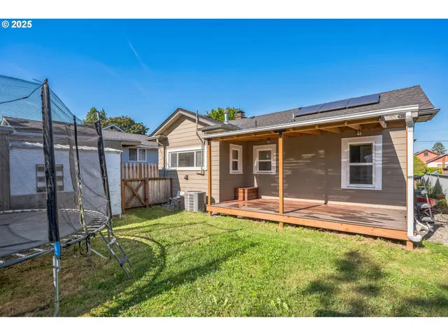 a view of a house with a yard and sitting area