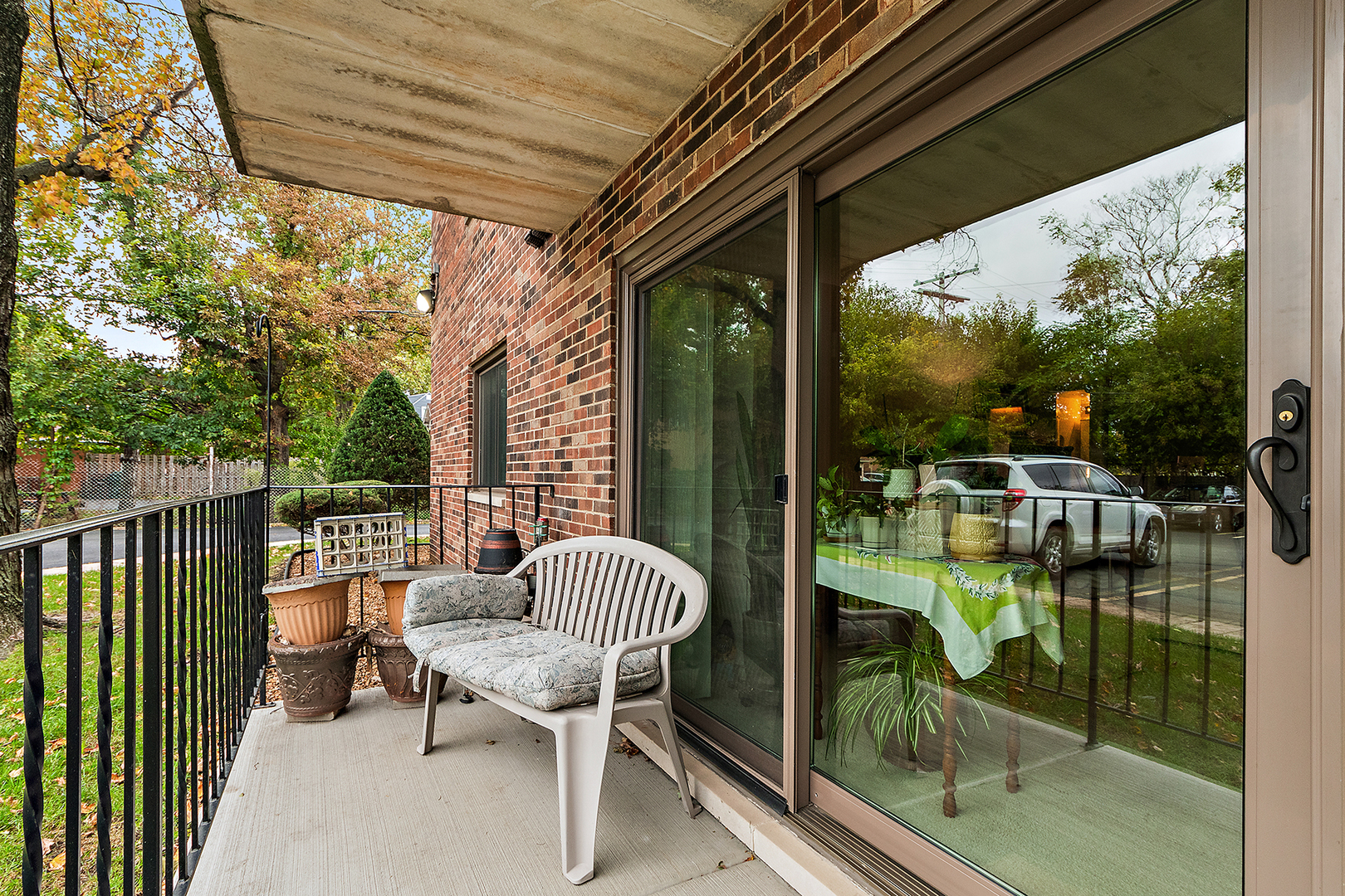 1940 183rd Street, Unit 1C Homewood, IL 60430 - Photo 13 of 16 a view of a chair and tables in the balcony
